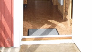 Un intérieur en bois avec une porte donnant sur un couloir.