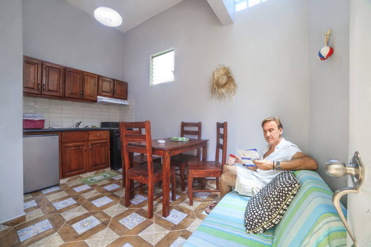 A small, compact living space with a kitchenette, a dining area, and a seating area.