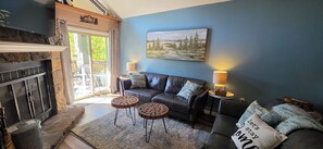 A living room with a fireplace, a sofa, two side tables, and a painting on the wall. - 2.7 miles from the Gatlinburg strip.
7th night free and Last minute discount!  (Gatlinburg)