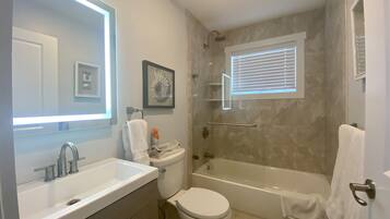 Combined shower/tub, hair dryer, towels, soap