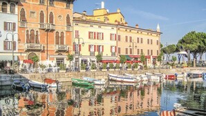 A waterfront area with buildings, outdoor seating, and boats. - 2 bedroom pet friendly apartment in Tremosine -BS- (Tremosine -BS-)