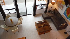 A modern living room with a round table, two armchairs, a sofa, and a coffee table. - Cascades View A Frame (Snohomish)