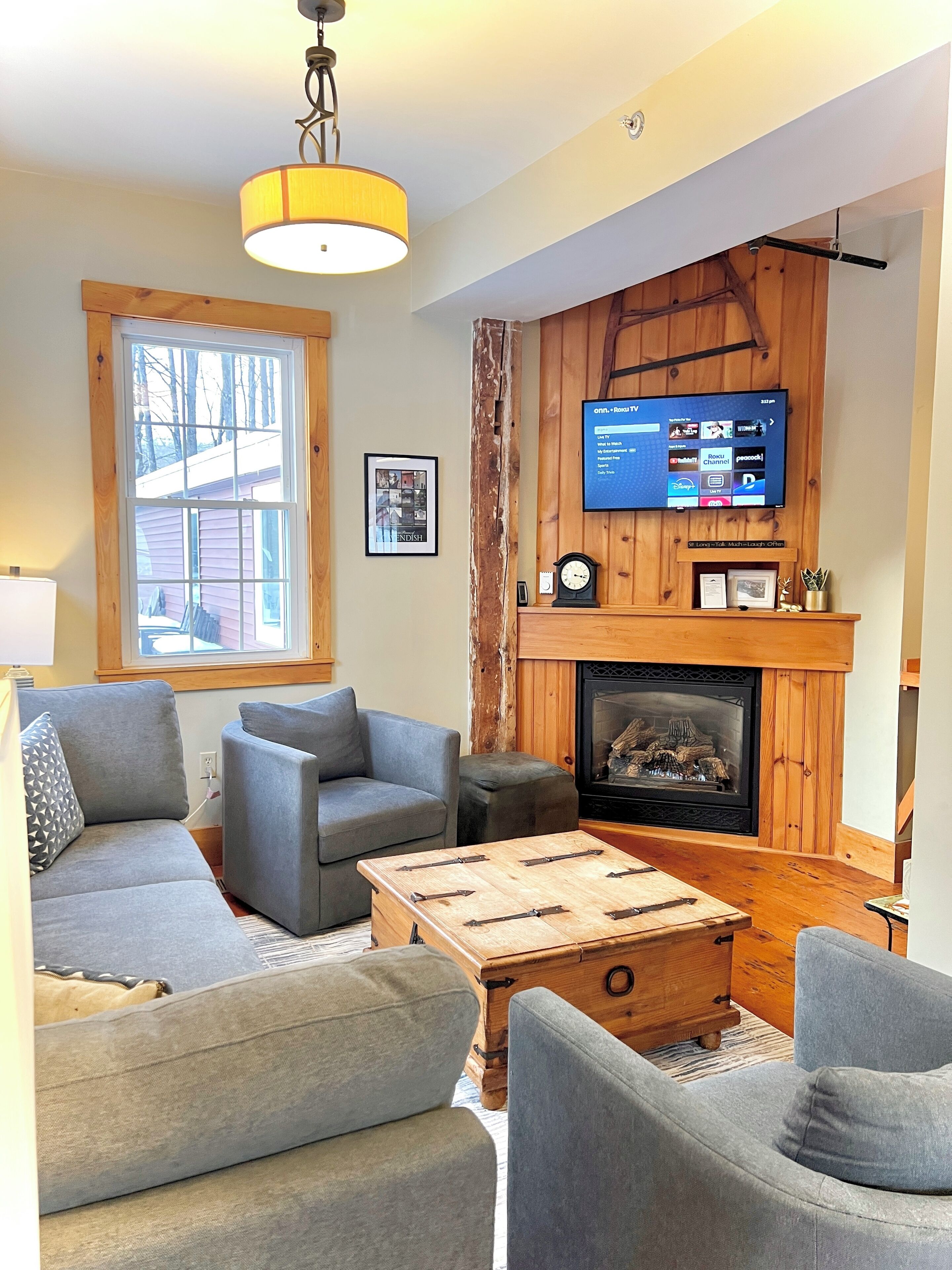 Smart TV, fireplace, books, computer monitors