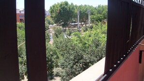 A view from a balcony with a metal railing, overlooking a park with trees and a clear sky. - ATTIC + PRIVATE TERRACE AND FREE WIFI (Sevilla)