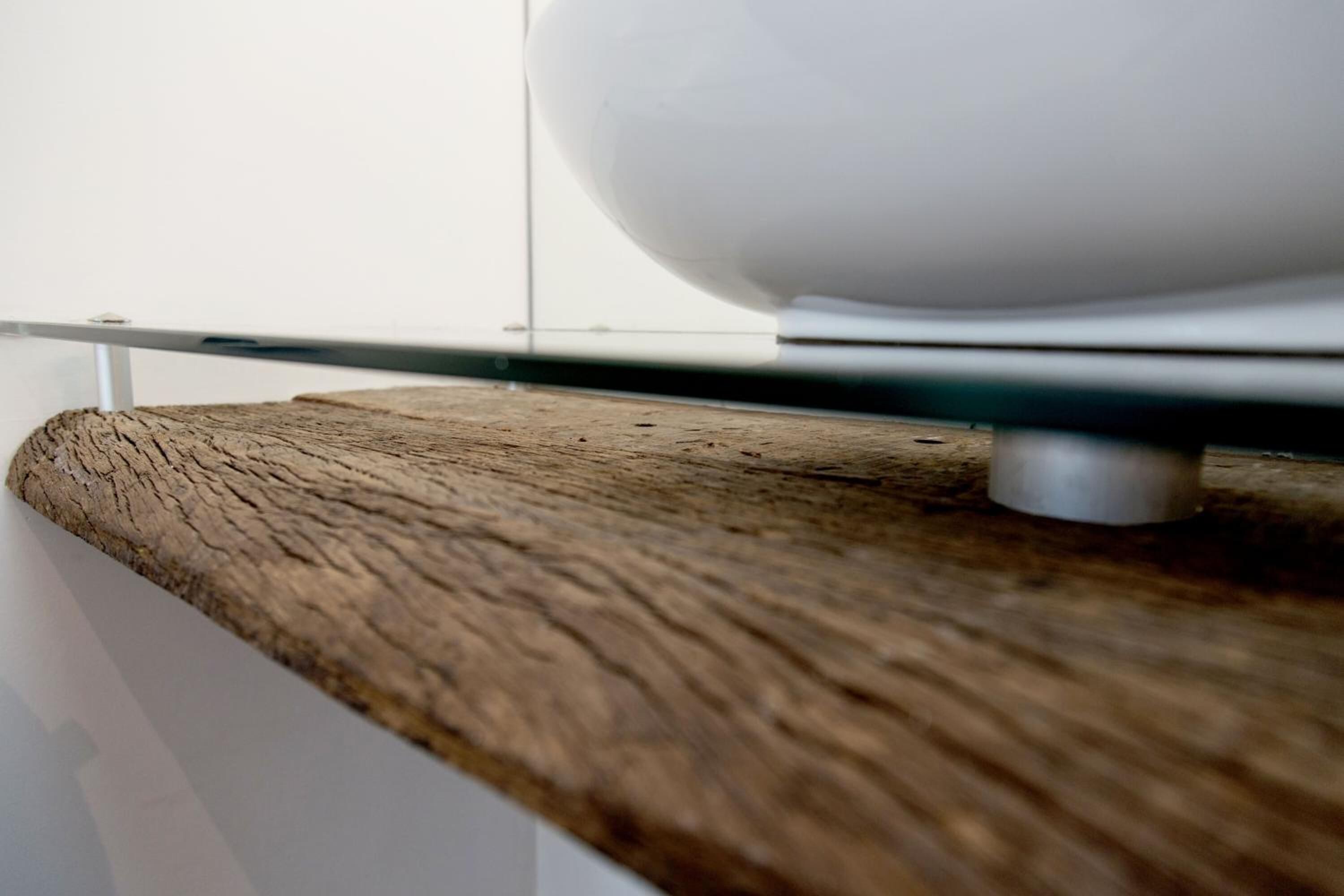 A wooden shelf with a white object on it.