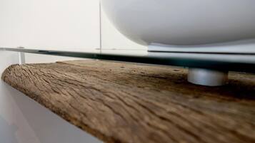 A wooden shelf with a white object on it.