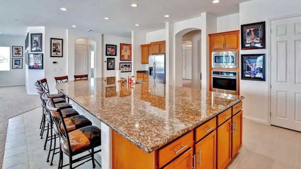A spacious kitchen with a granite countertop, wooden cabinets, and stainless steel appliances. - 6 Minutes from Airport, 8 Minutes to Strip,  Sleeps 14  6 Bedroom, 4 Bath (Las Vegas)