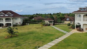A residential area with houses featuring balconies, solar panels, and a well-maintained lawn. - Your Secret Paradise , Richmond-St.Ann (St.Anns)