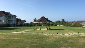 A gazebo in a well-maintained grassy area with a clear sky. - Your Secret Paradise , Richmond-St.Ann (St.Anns)