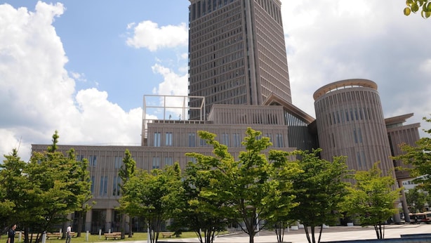 A modern building with a tall central tower and a cylindrical structure to the right. - Yamagata Eki Nishiguchi Washington Hotel (Yamagata)