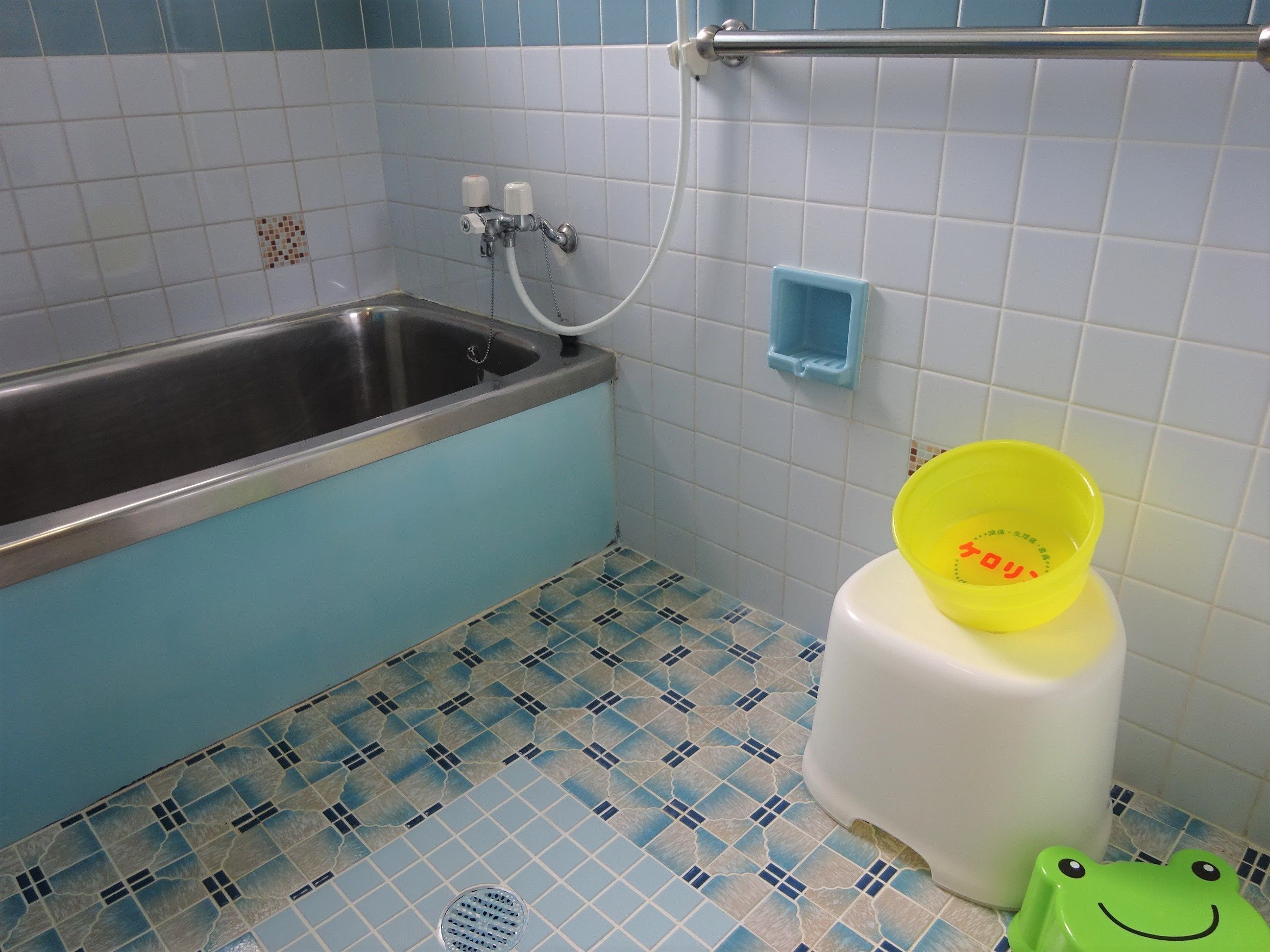 A bathroom with a bathtub, a toilet, and a shower.