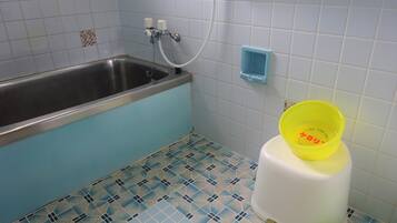 A bathroom with a bathtub, a toilet, and a shower.