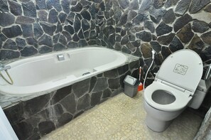 Combined shower/bathtub, deep-soaking bathtub, towels