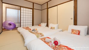 A traditional Japanese-style hotel room with tatami flooring, a shoji screen, and a purple umbrella. - Stay SAKURA Kyoto To-ji Machiya (Kyoto)