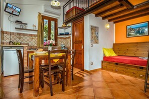 Cozy retreat with a kitchenette, dining area, and comfortable bed.