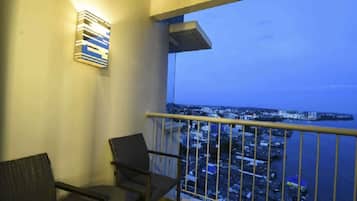 A balcony with a view of a cityscape and water.