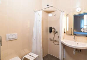 A modern bathroom with a shower, toilet, and sink. - B&B Hotel Limoges 1 (Limoges)