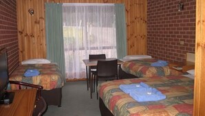 A room with two beds, a desk, and a chair. - Orbost Country Road Motor Inn (Orbost)