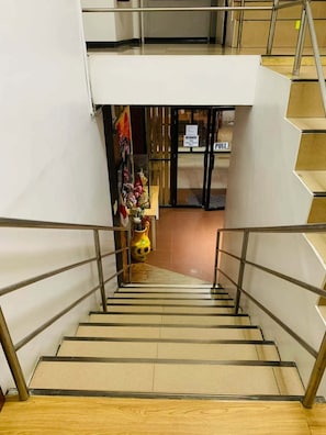 A staircase with metal railings leading to a second-floor area.