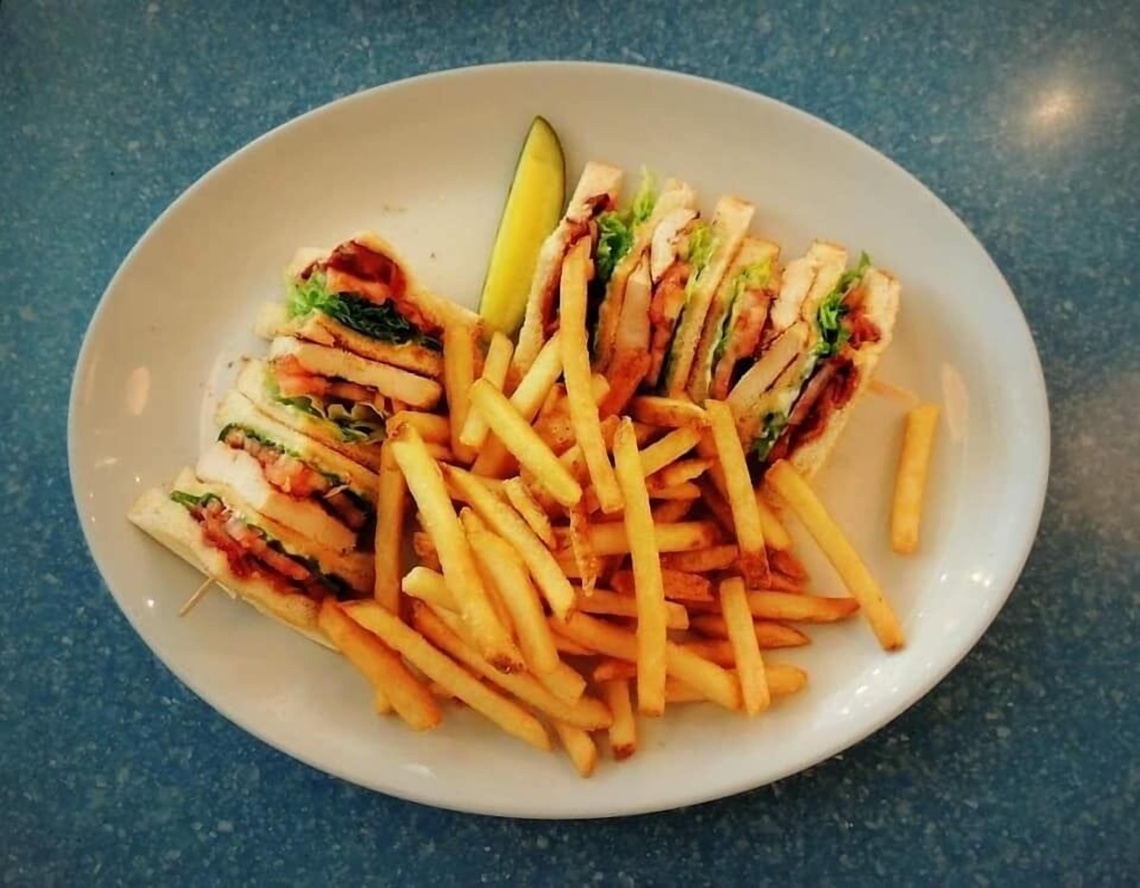 A plate with a sandwich and fries.