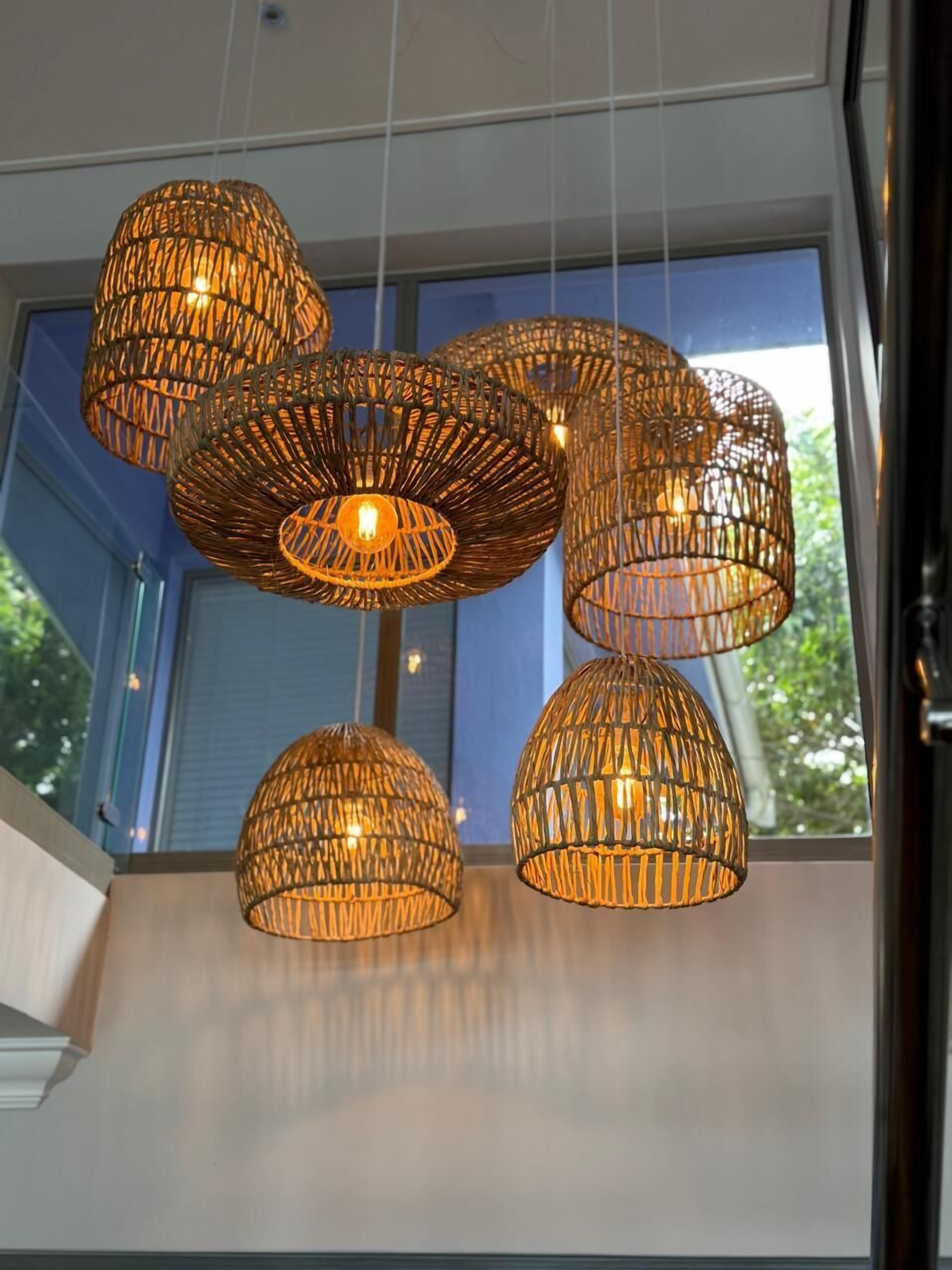 A modern interior with multiple hanging wicker light fixtures.