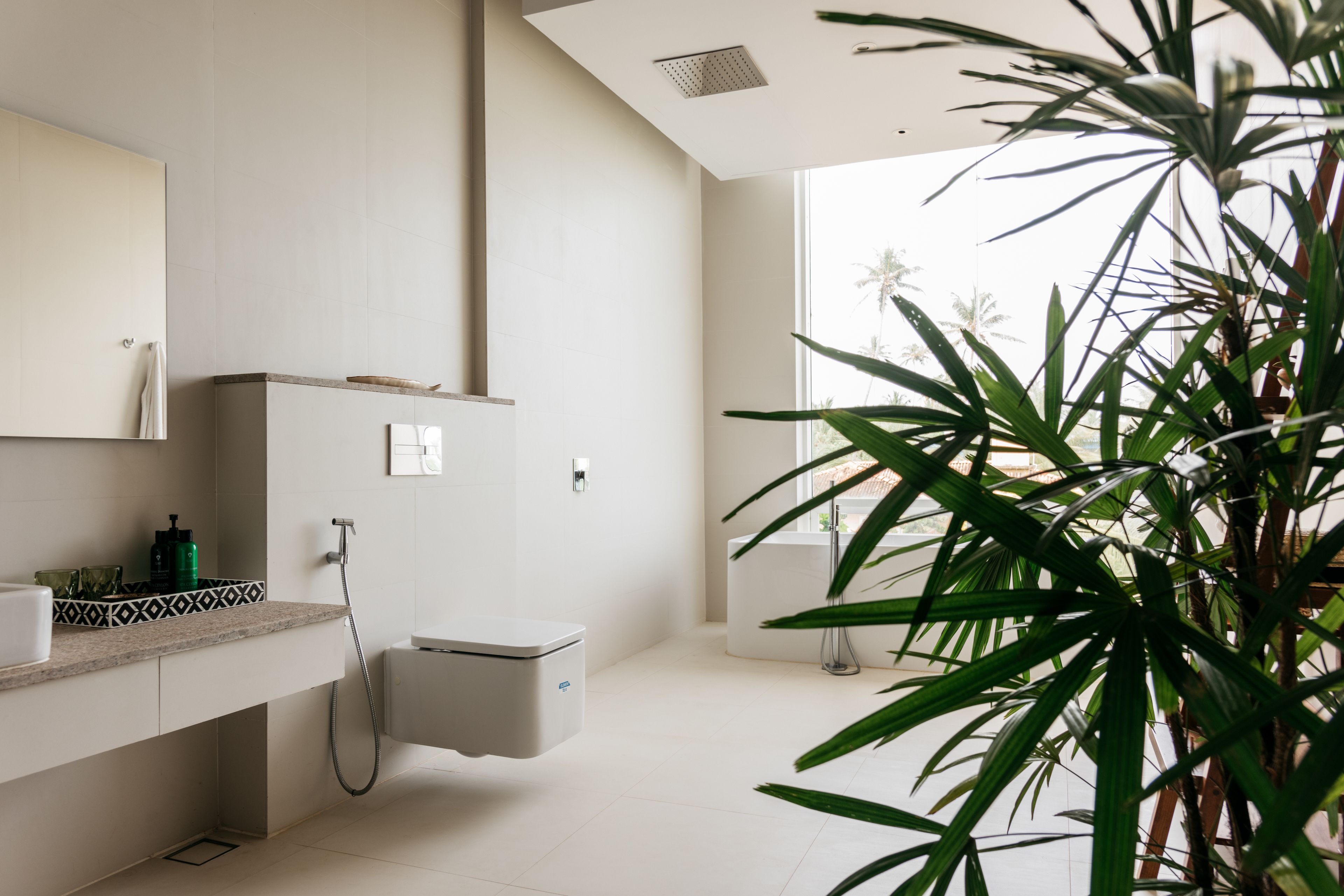 A modern bathroom with a shower, toilet, and sink.