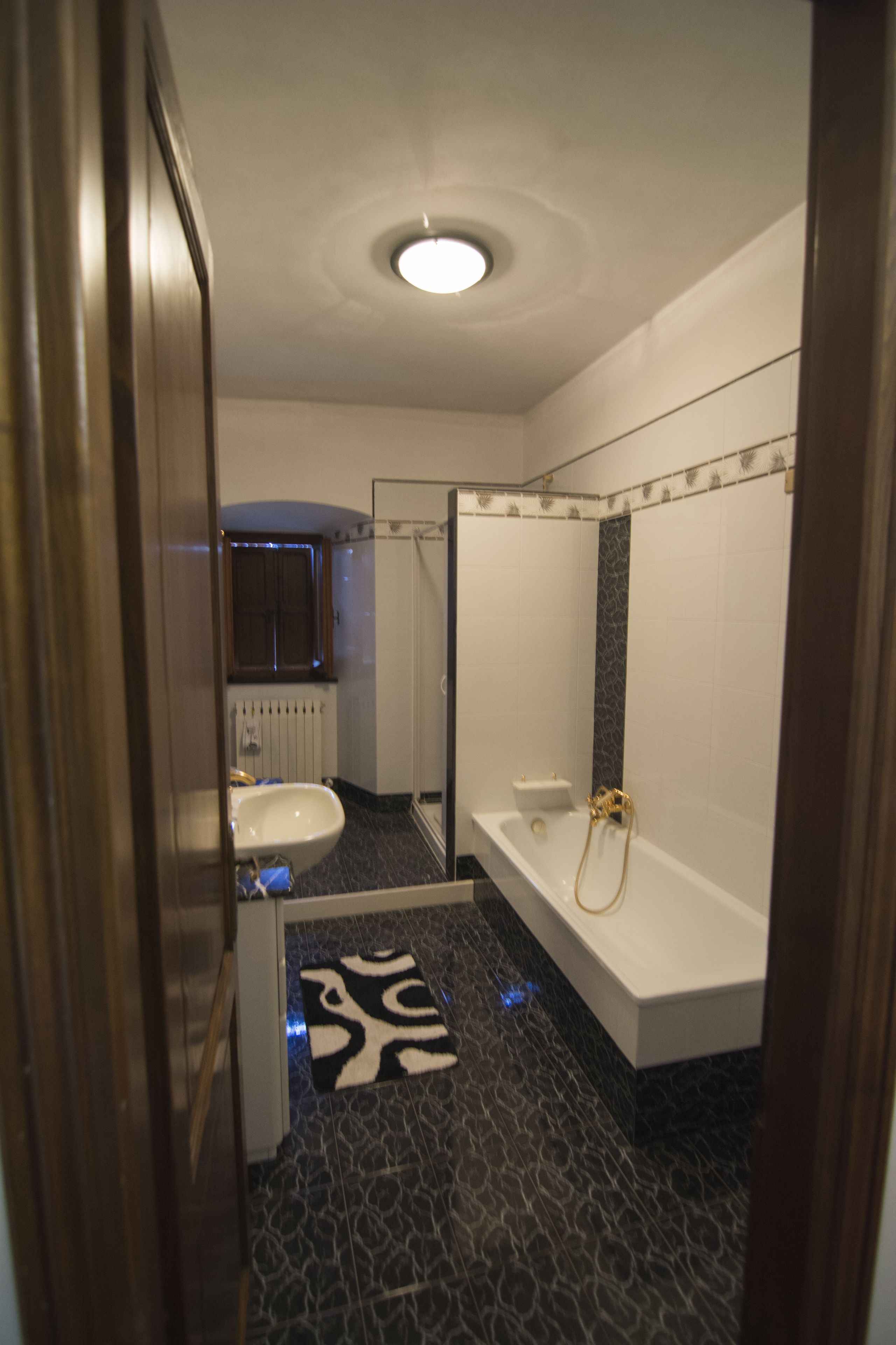A bathroom with a white sink, a bathtub, and a shower.