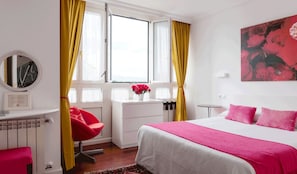 A bedroom with a bed, a chair, a desk, and a window with curtains. - La Casa de Las Camelias (Valdes)