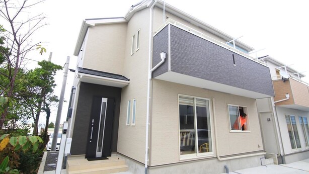 A modern two-story building with a flat roof, a front door, and a visible window. - Guest House Rion (Yomitan)