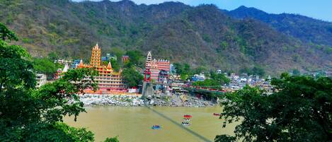 A riverside town with a prominent temple and a bridge.