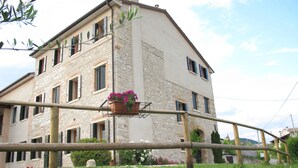 A multi-story building with stone facade and multiple windows.