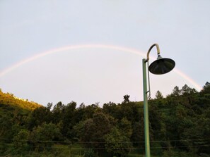 A street lamp with a rainbow in the background. - Cottages at Village (Nainital)