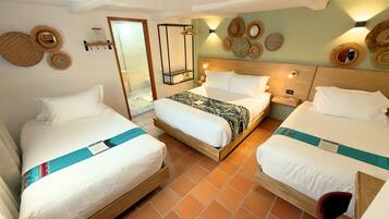 A hotel room with two beds, a wooden headboard, a nightstand, and a wall-mounted mirror.