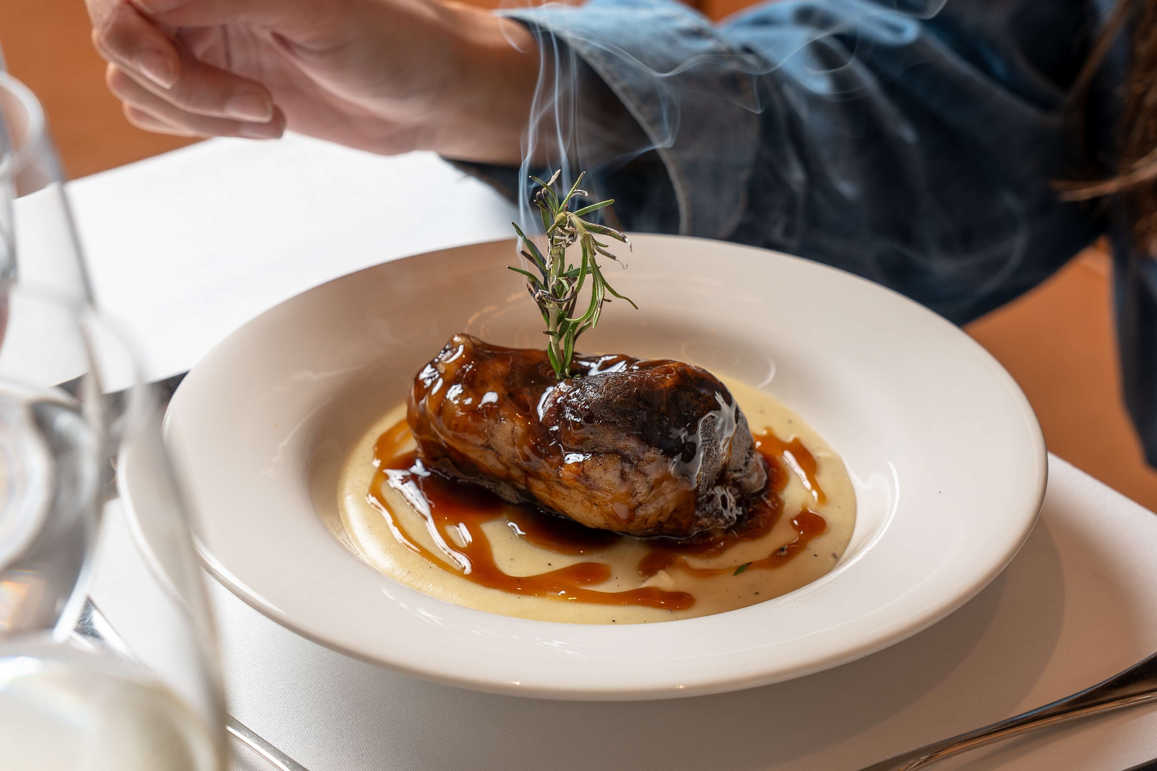 Un plato blanco con un adorno de romero.