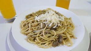A plate of spaghetti with meat and cheese on a white plate. - Free Zone Hotel (Hjar Ennhal)