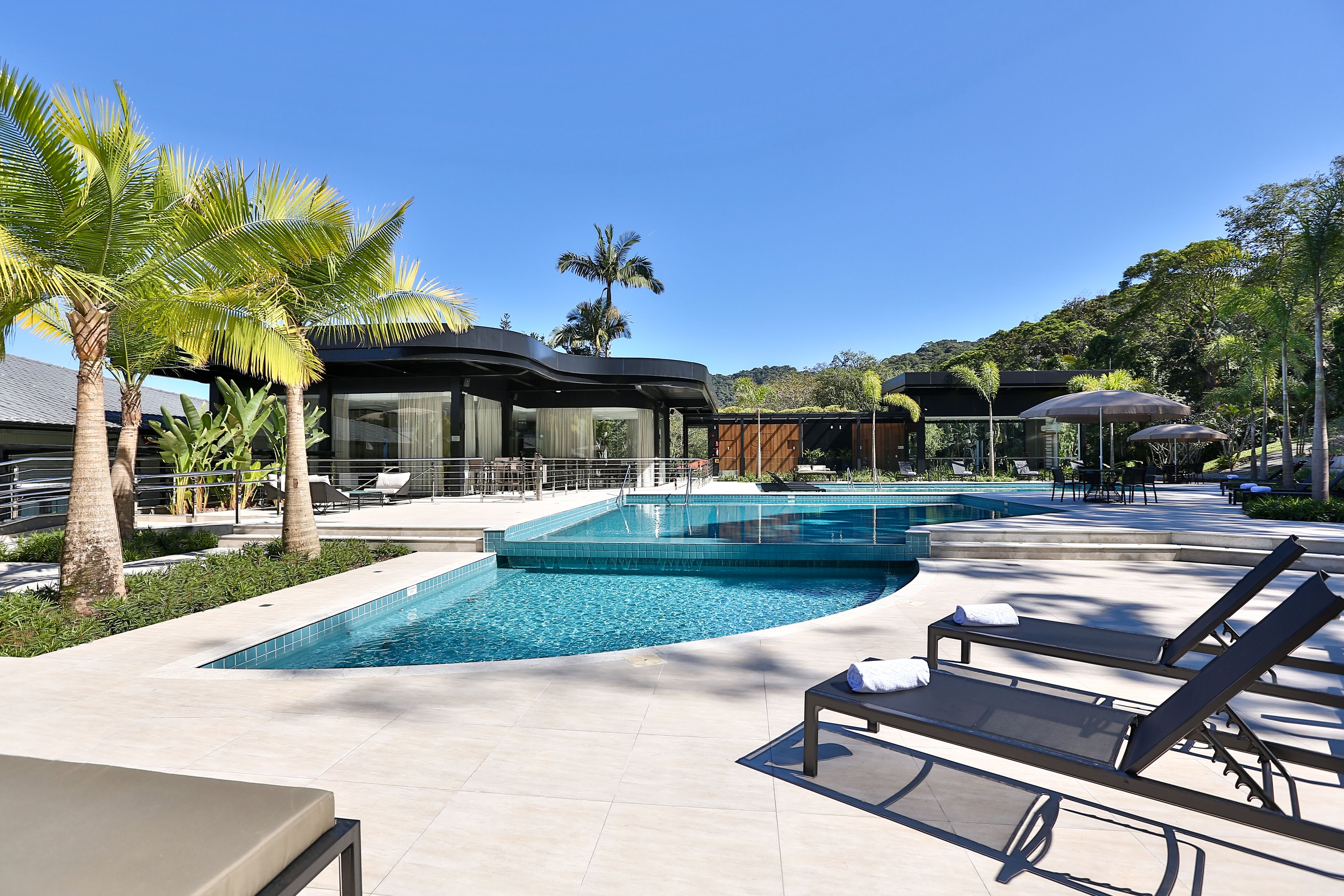 3 outdoor pools, open 6 AM to 10 PM, pool umbrellas, pool loungers