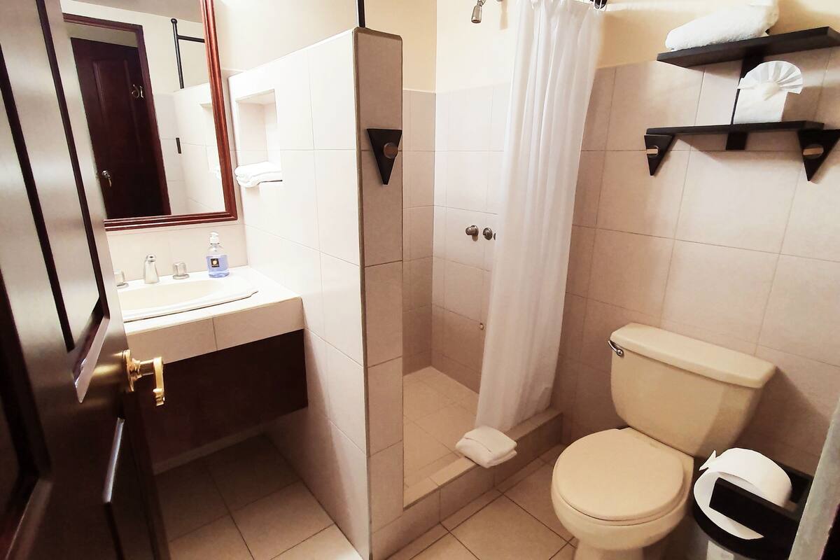 standard single room | bathroom | shower, free toiletries, hair dryer, towels