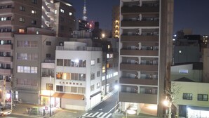 A multi-story building with a modern architectural design, featuring balconies and a ground-floor commercial space. - bnb+ Asakusa Kuramae - Hostel (Tokyo)
