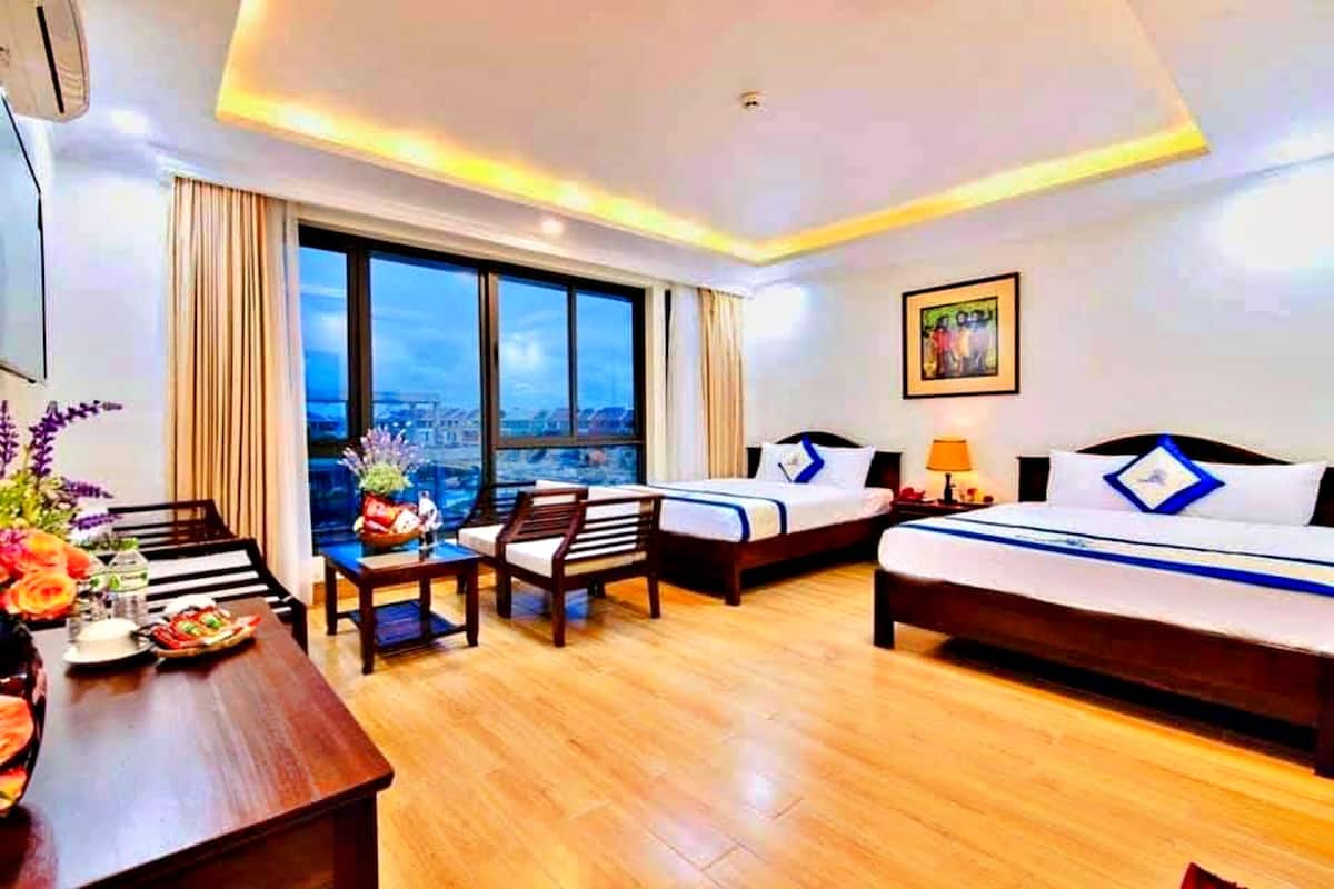 deluxe family room | premium bedding, desk, laptop workspace, blackout curtains