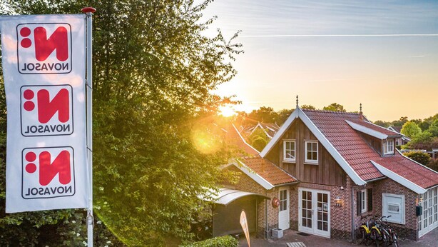 A traditional wooden building with a sloped roof, a brick facade, and a small porch area with benches. - Amazing home in Hoge Hexel with WiFi (Hoge Hexel)