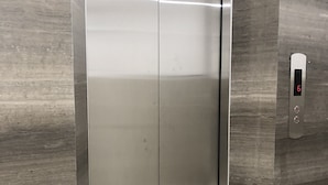 A modern elevator with a digital display showing the number 6. - Queen Hotel 7 (Nha Trang)