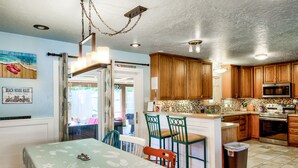 A compact kitchen with wooden cabinets, a microwave, and a sink.