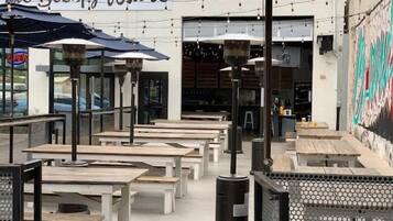 An outdoor seating area with tables and umbrellas at 'The Sleepy Whale'.