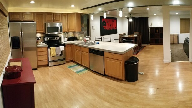 A modern kitchen with wooden cabinets, stainless steel appliances, and a central island. - Skiing, Mt Biking, Climbing, Hiking, Boating, Swimming, ATV Trails. (Bountiful)