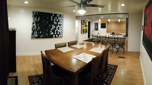 A dining area with a wooden table and chairs, a ceiling fan, and a kitchen in the background. - Skiing, Mt Biking, Climbing, Hiking, Boating, Swimming, ATV Trails. (Bountiful)