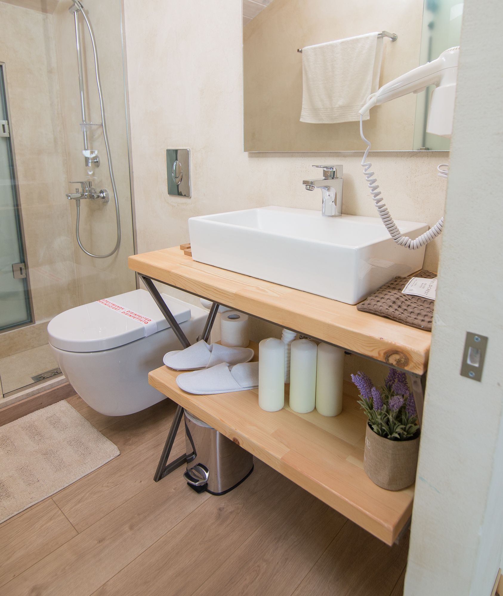 A modern bathroom with a shower, toilet, and sink.