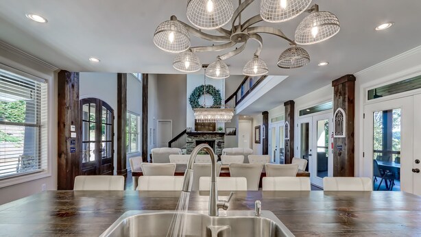 A spacious kitchen with a large island, stainless steel sink, and a chandelier. - Executive Retreats, Family Reunions, Near Montaluce, 8 King Beds  (Dahlonega)