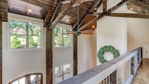 A spacious interior with high ceilings, large windows, and a wooden ceiling structure. - Executive Retreats, Family Reunions, Near Montaluce, 8 King Beds  (Dahlonega)