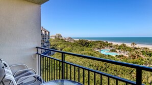 A balcony with a view of a beach and a swimming pool. - Beautiful Oceanfront, 3br/2ba Beachwalker (Amelia Island)