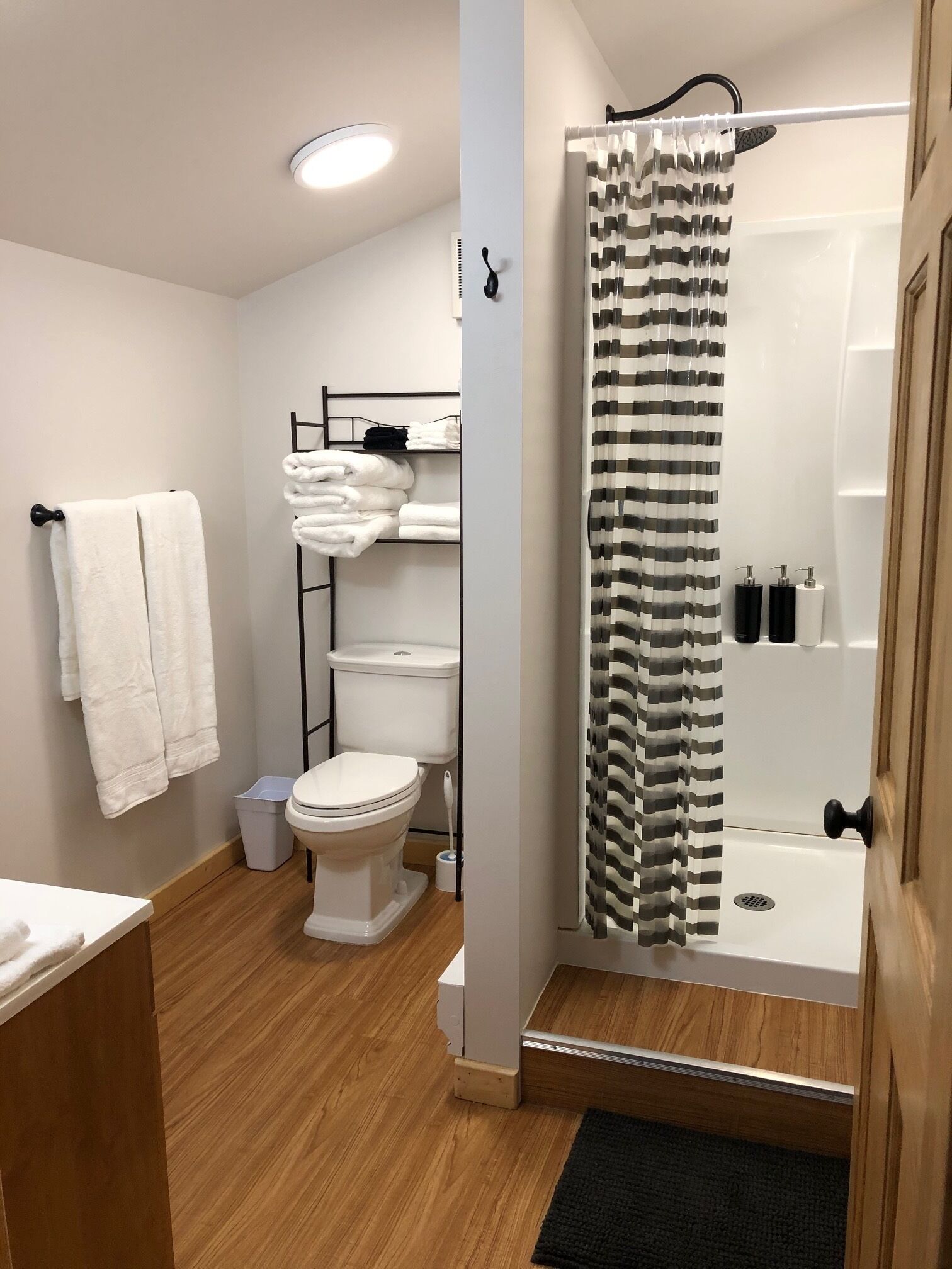 Shower, rainfall showerhead, hair dryer, towels